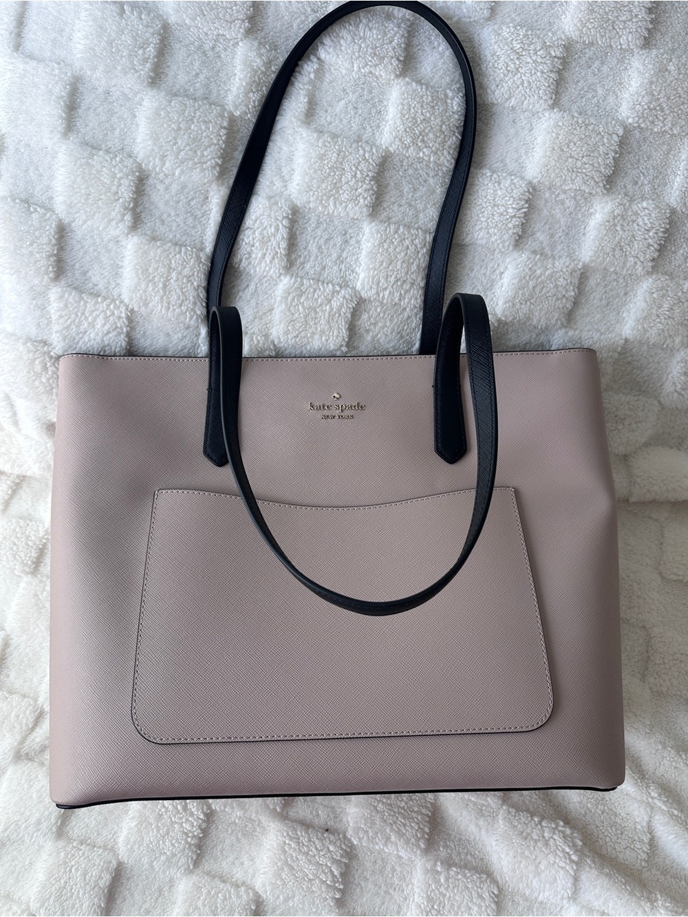 kate spade pale pink leather tote with black straps and matching pouch.